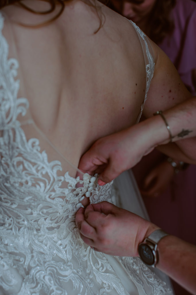 Detail shot of the wedding dress being bottomed up