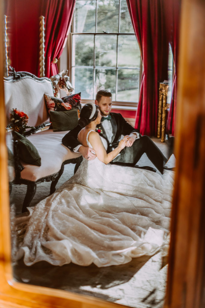 Bride and groom sitting on the floor in the honeymoon suite 