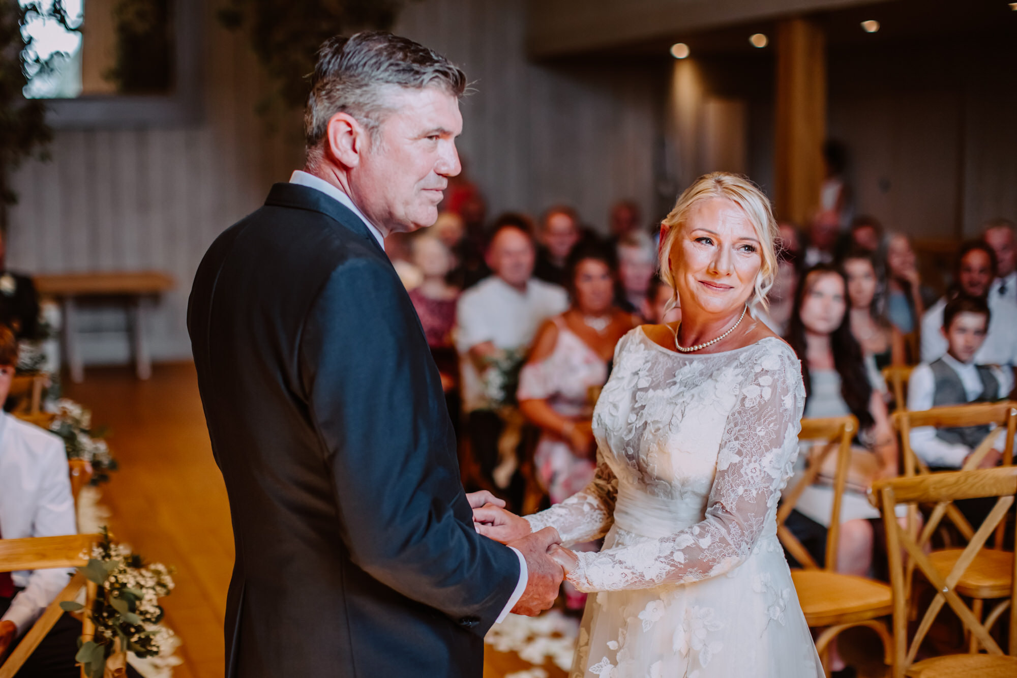 Bride and groom holding hands during the ceremony