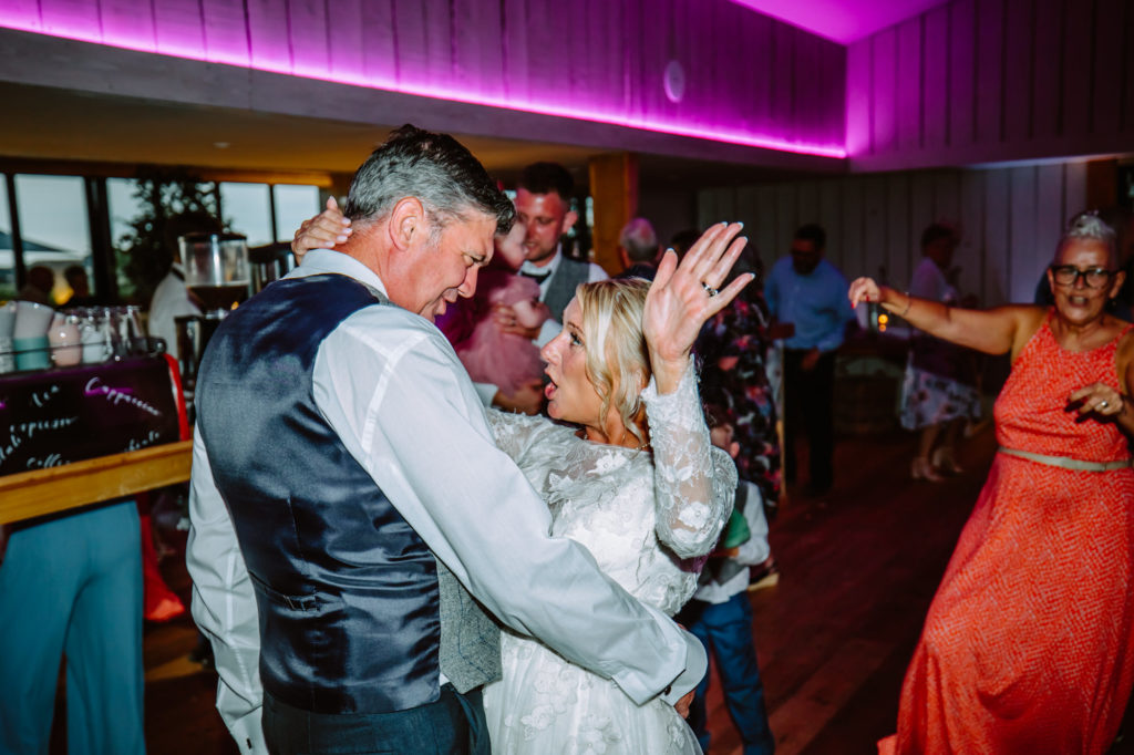 Bride and groom having fun while dancing to together
