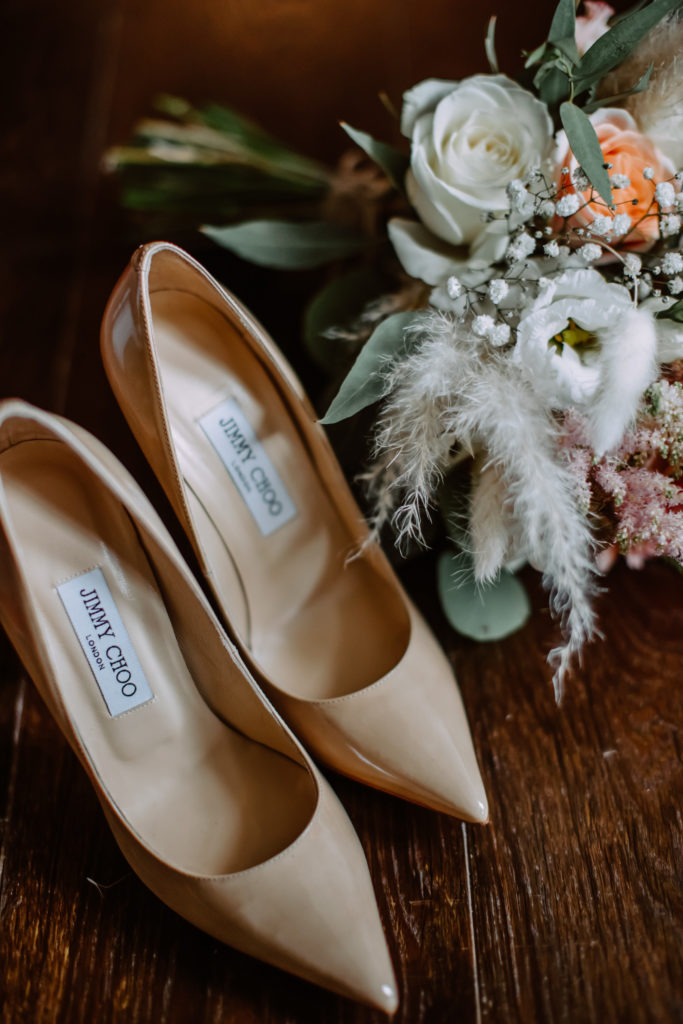 Bride's Jimmy Choo wedding shoes with a bridal bouquet