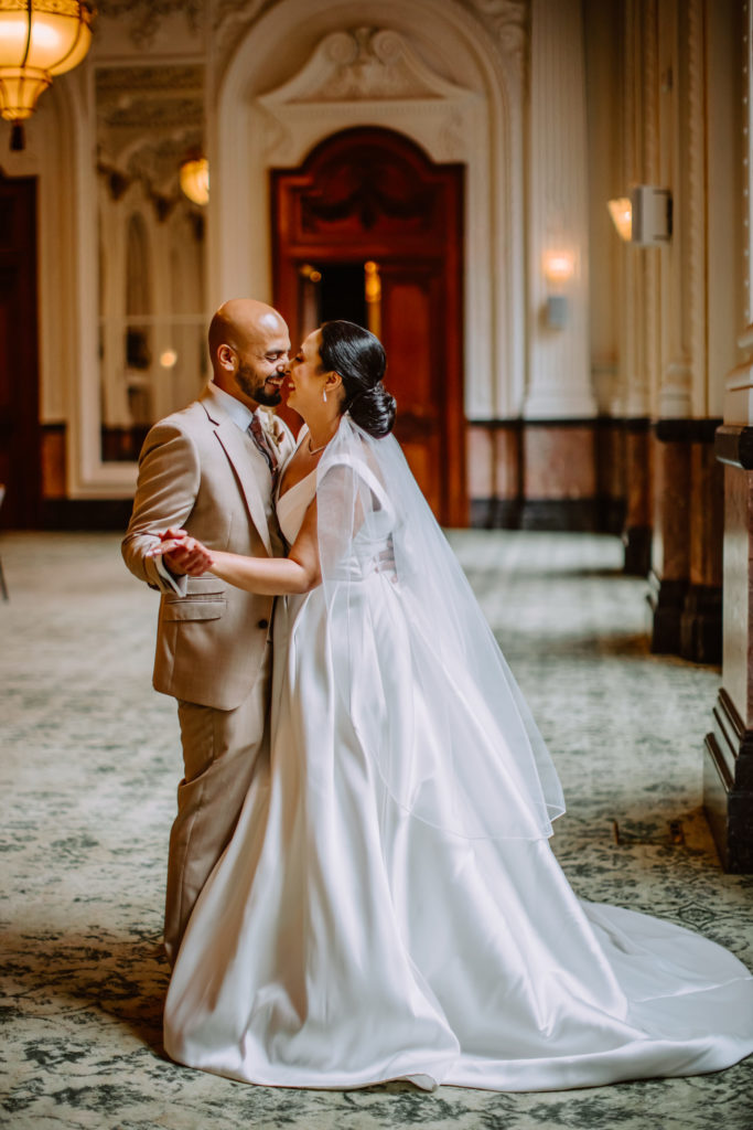 Bride and groom dancing together during their portraits in beautiful Ballroom of The Grand Hotel Birmingham
