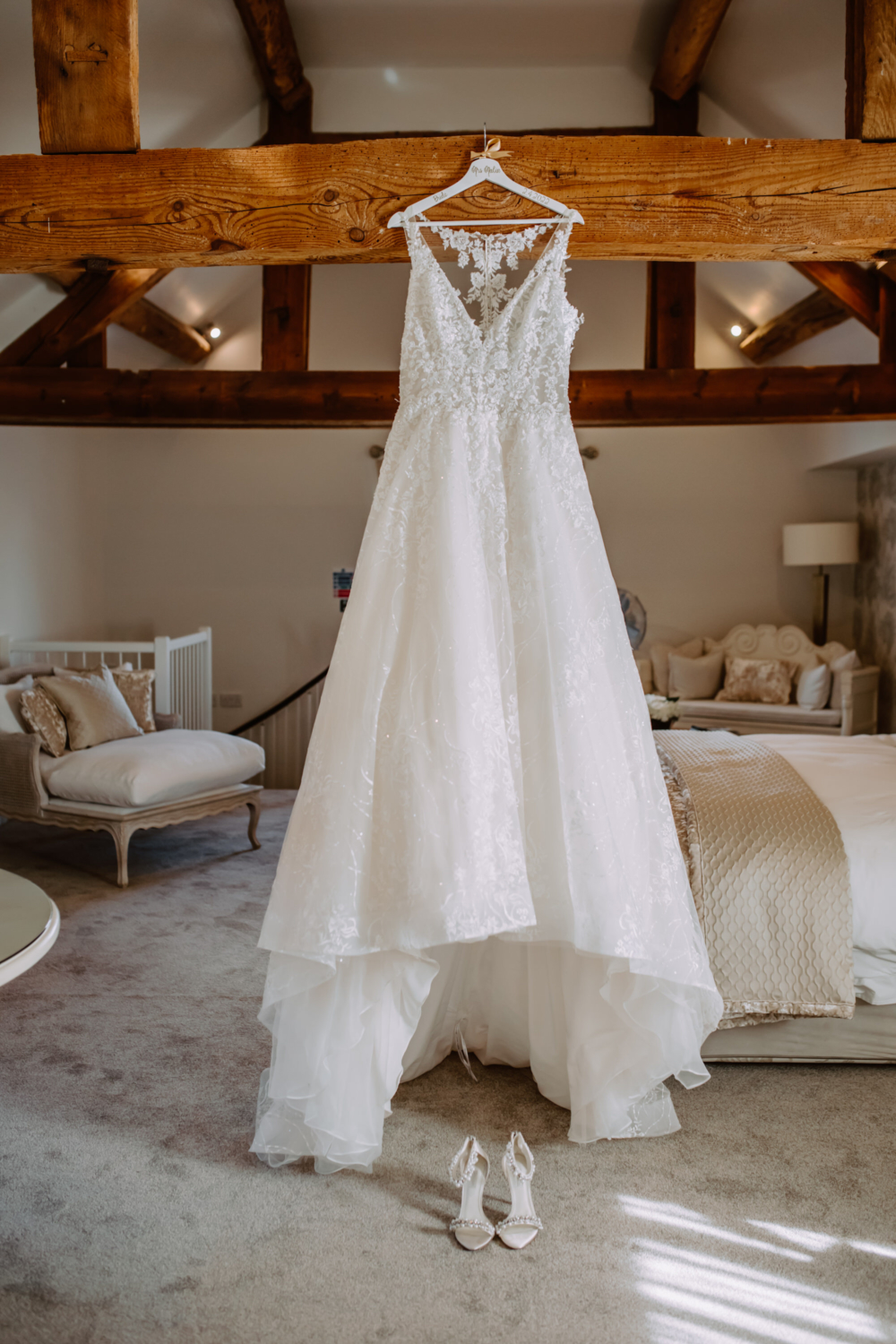 Wedding dress hanging from the beam in bridal suite 