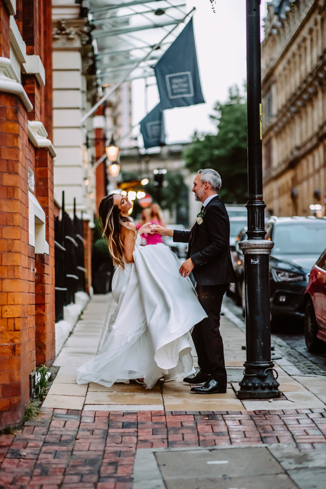 Freshly married couple dancing on the Church Street by the entrance of Hotel du Vin Birmingham 
