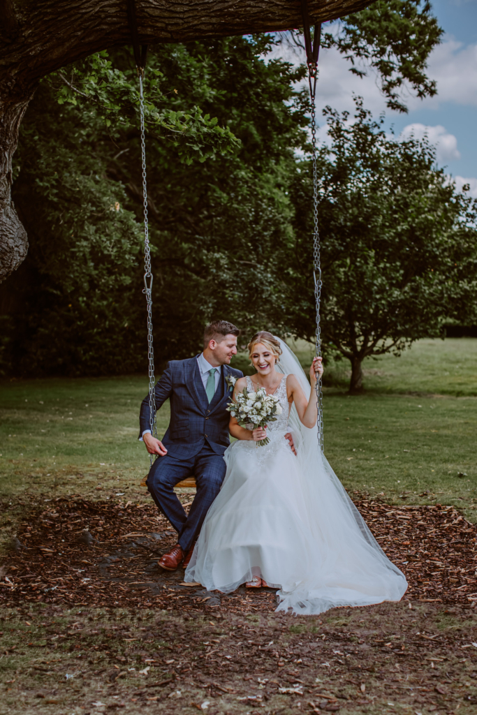 Freshly married couple on the swing while Penderll Hall wedding Photography