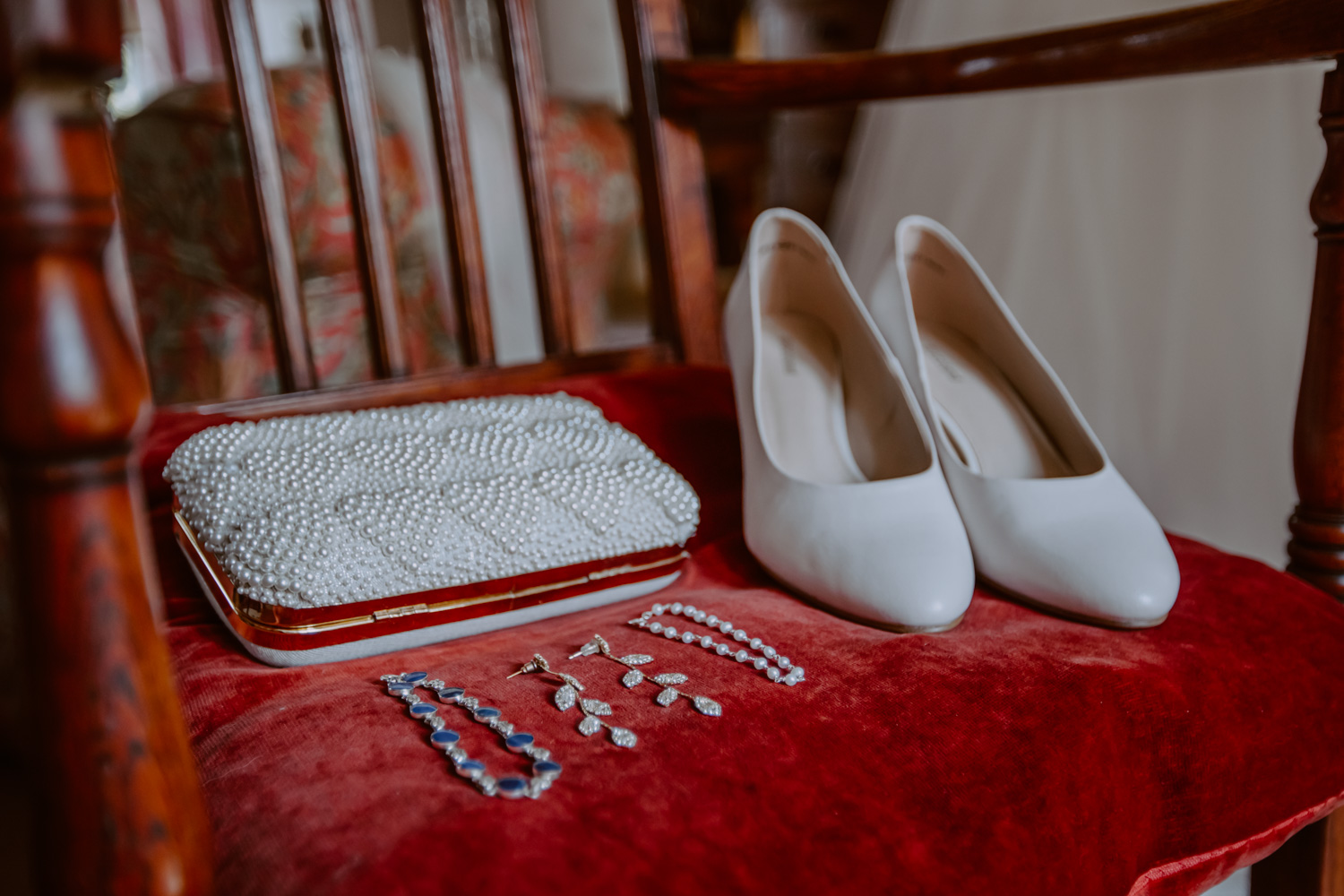 Detail photo of brides shoes, purse and jewelry 