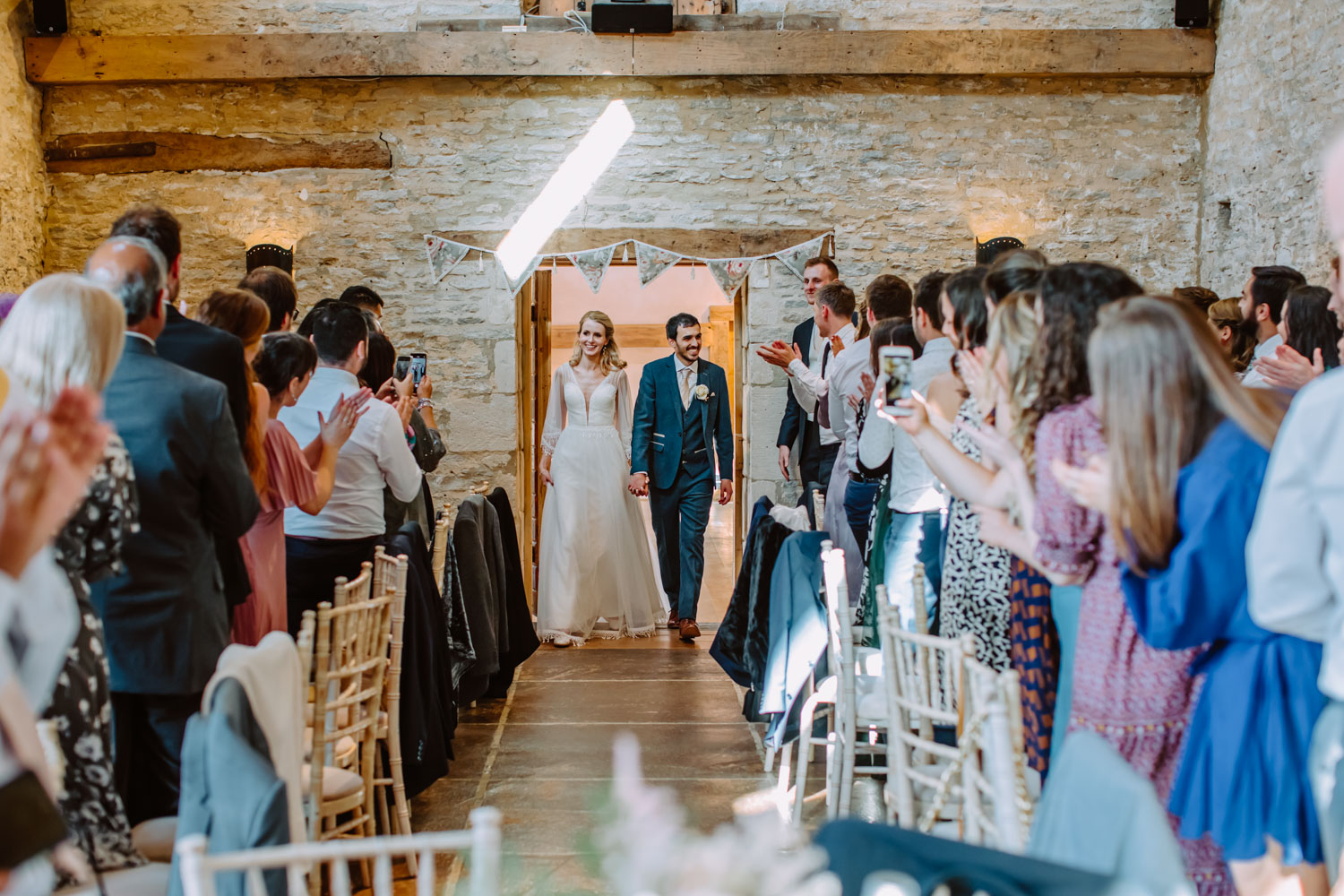 Oxleaze Barn wedding photography - Bride and groom's entrance to the wedding breakfast room 