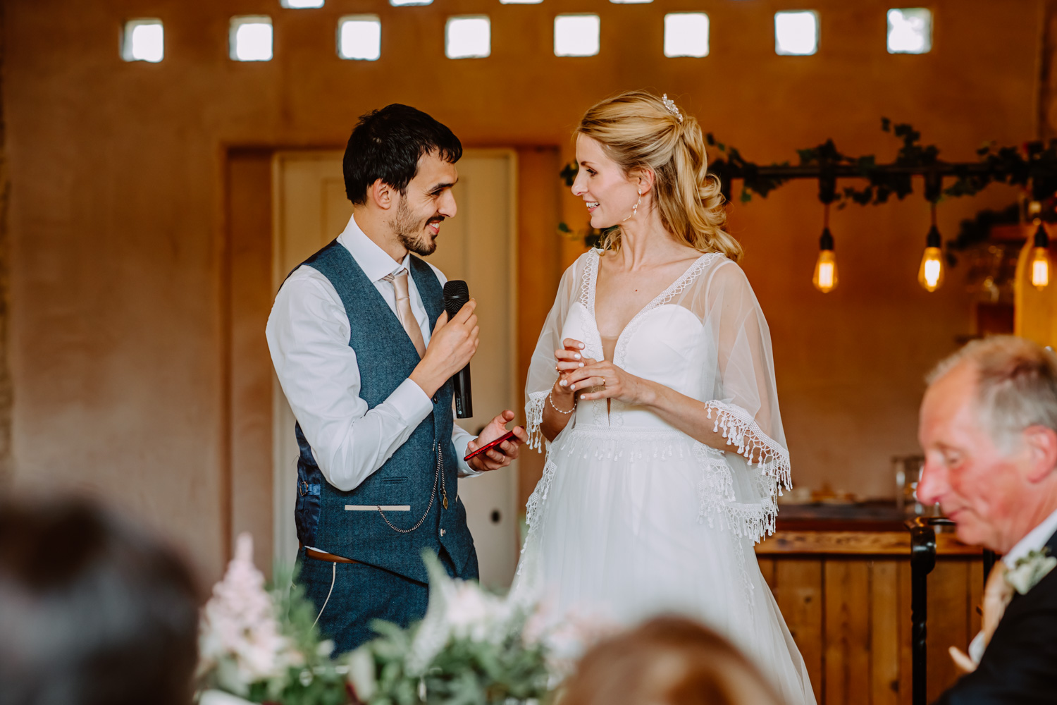 Bride and groom give their speech and smile at each other 