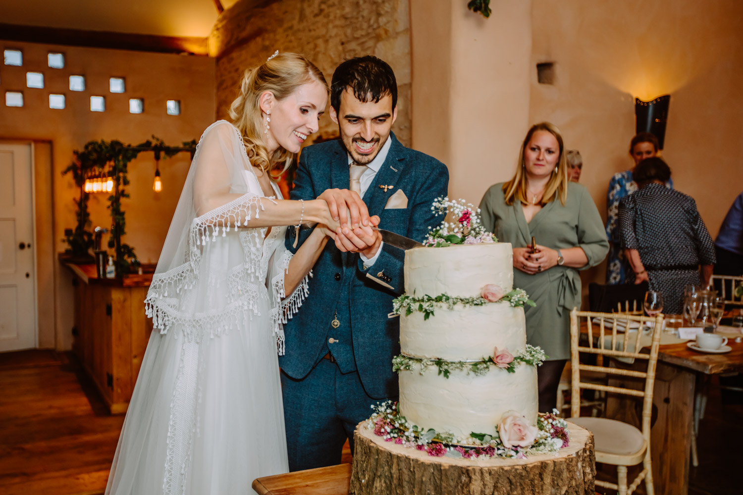 The couple cuts their wedding cake 