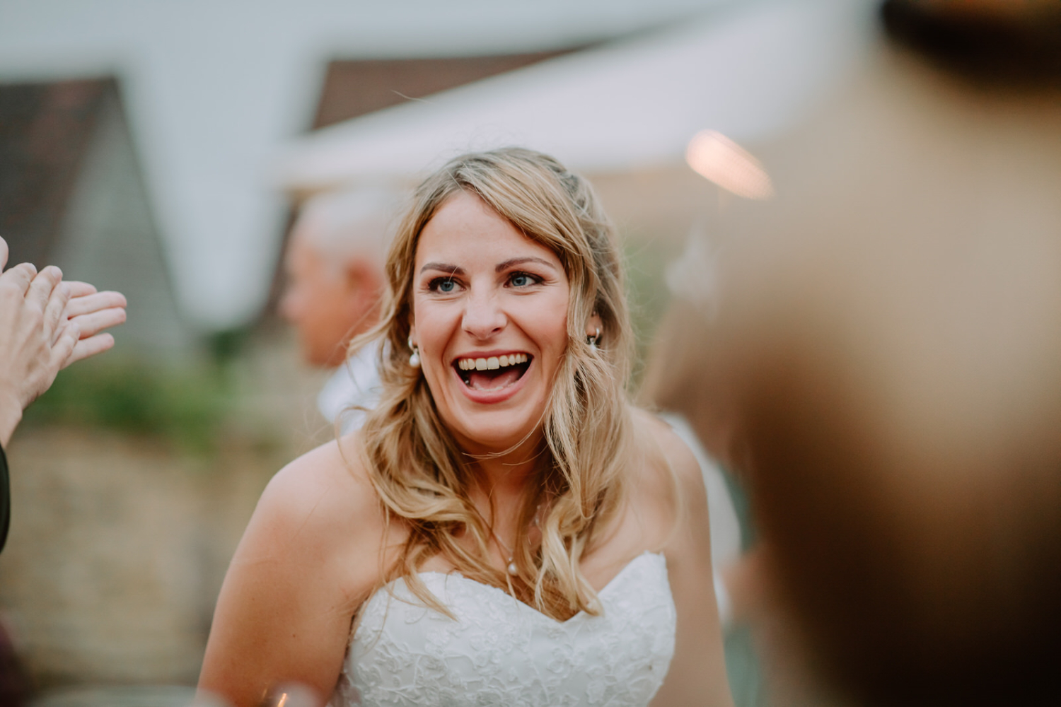 Detailed photo of the bride laughing.