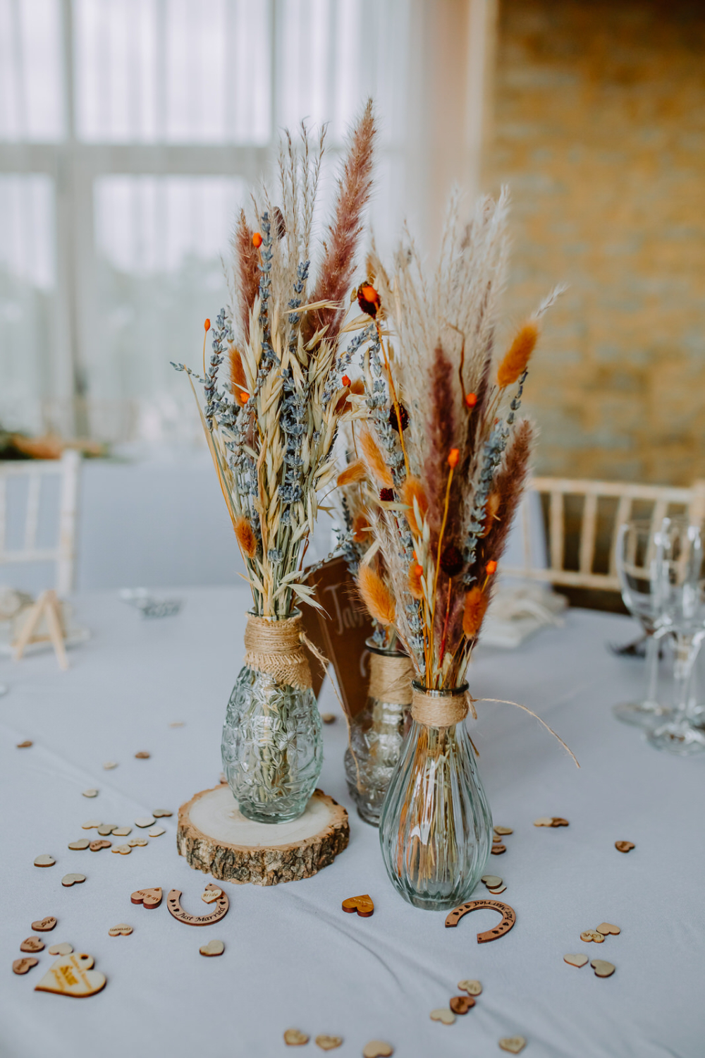Beautiful dried flowers in vase on the wedding breakfast table. 