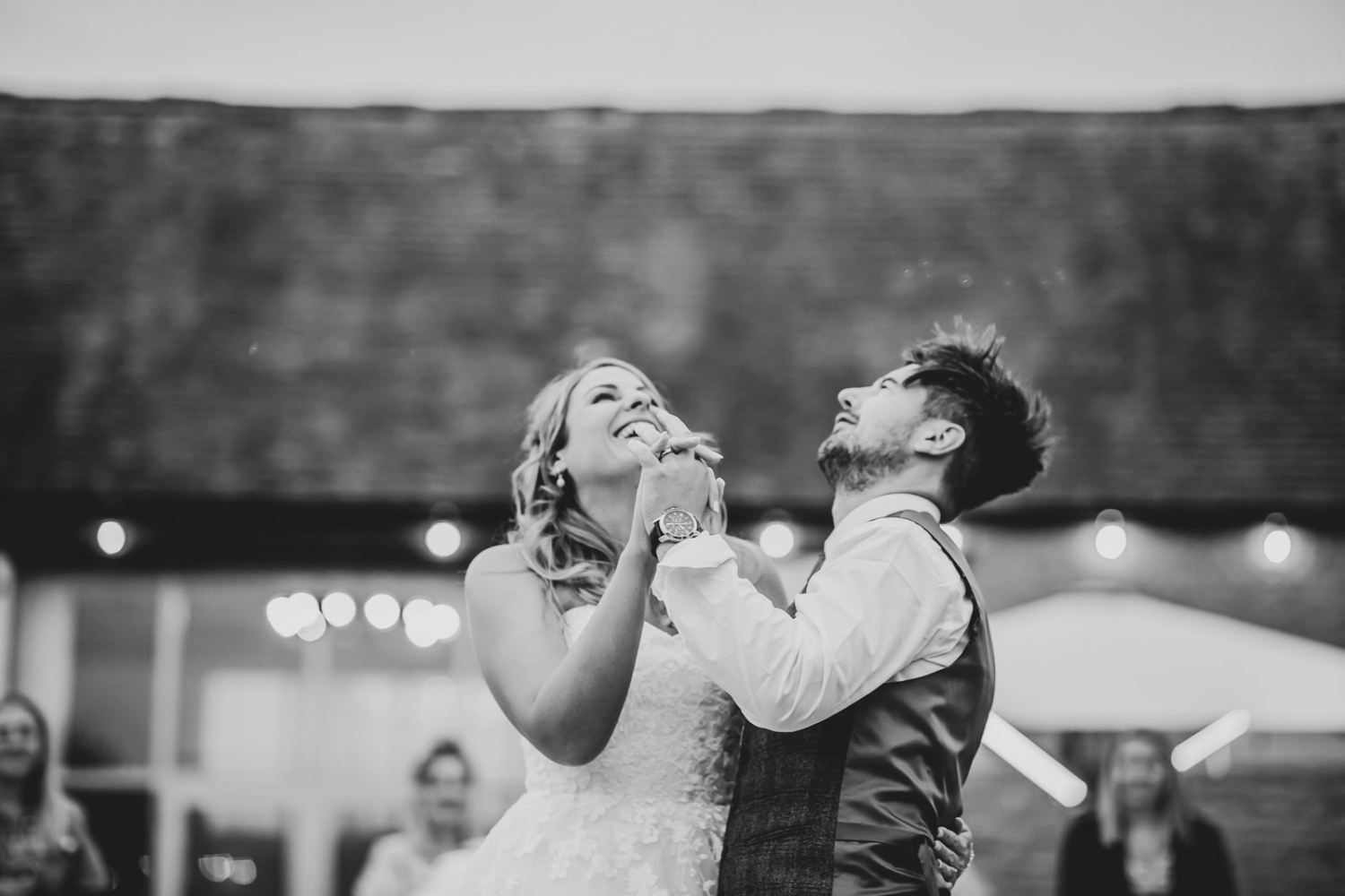 Black and white photo of bride and groom during the first dance outside 