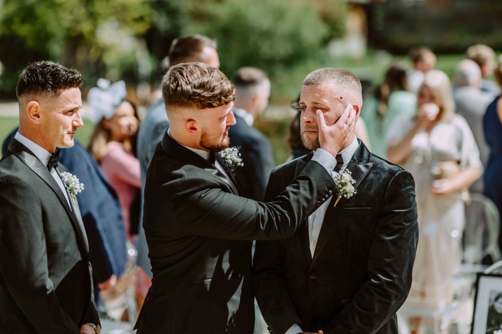 Best man wiping groom's tear before the bride's arrival.