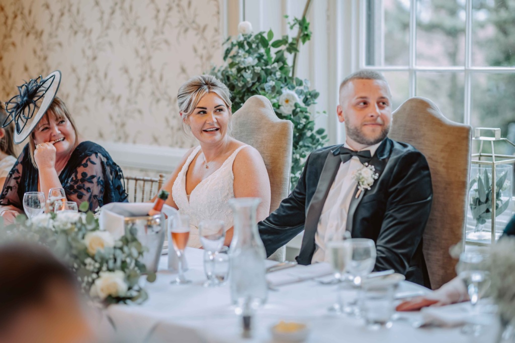 Newlyweds happily immersed in the joy of speeches