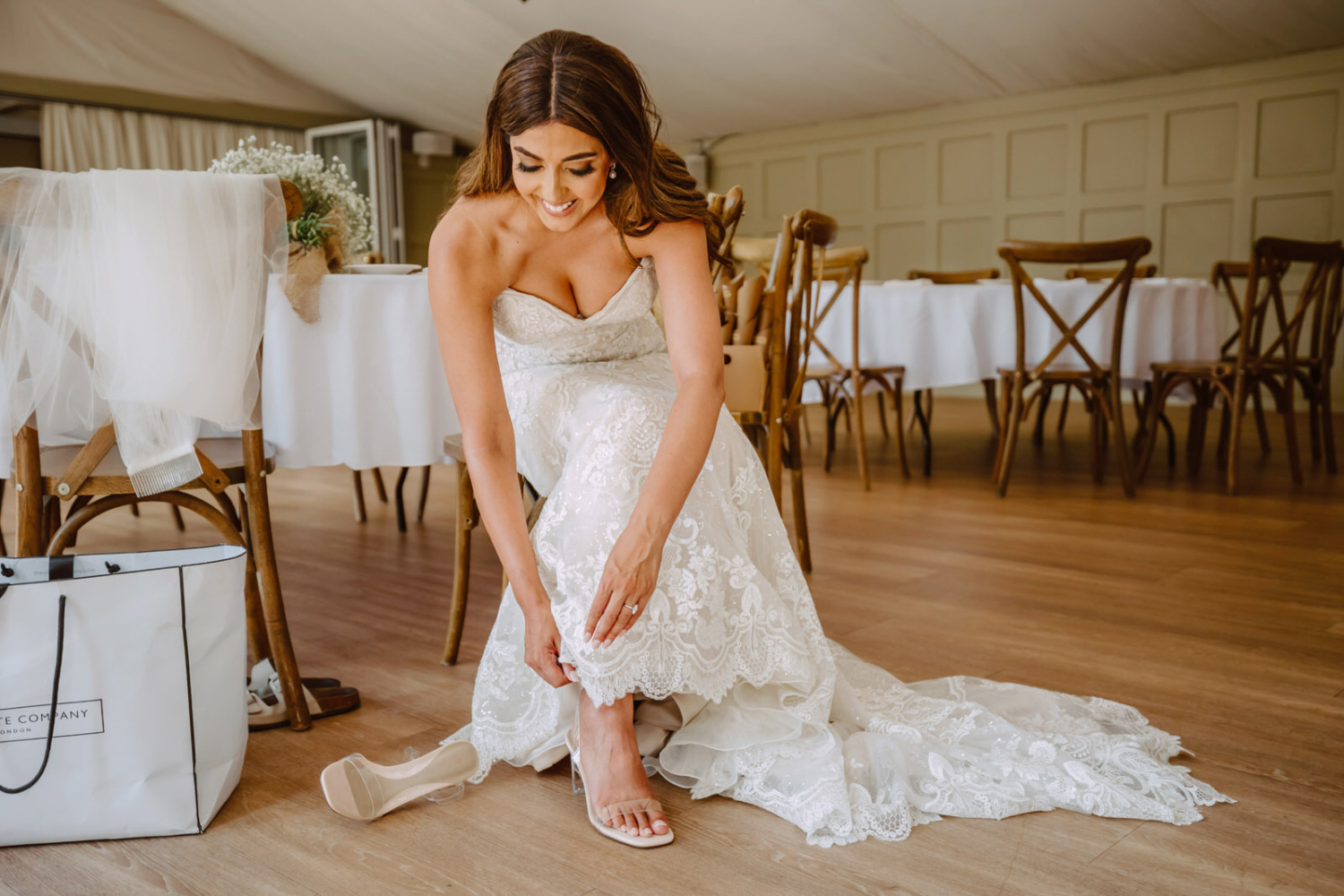 A bride putting on her wedding shoes.