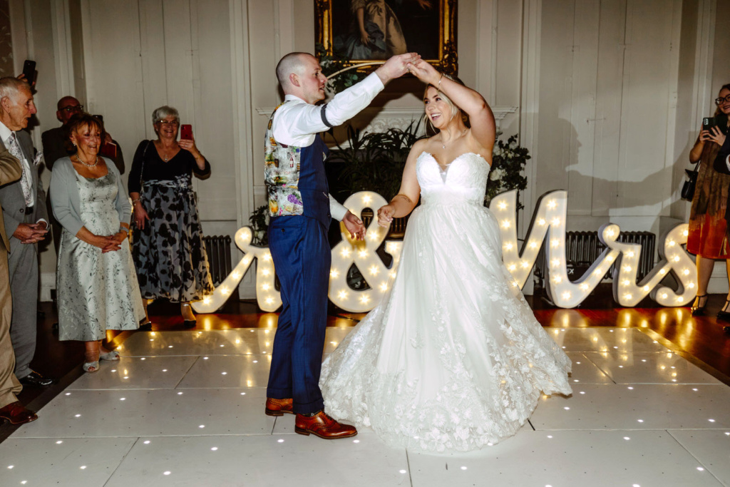 A bride and groom dancing on the dance floor at their wedding.