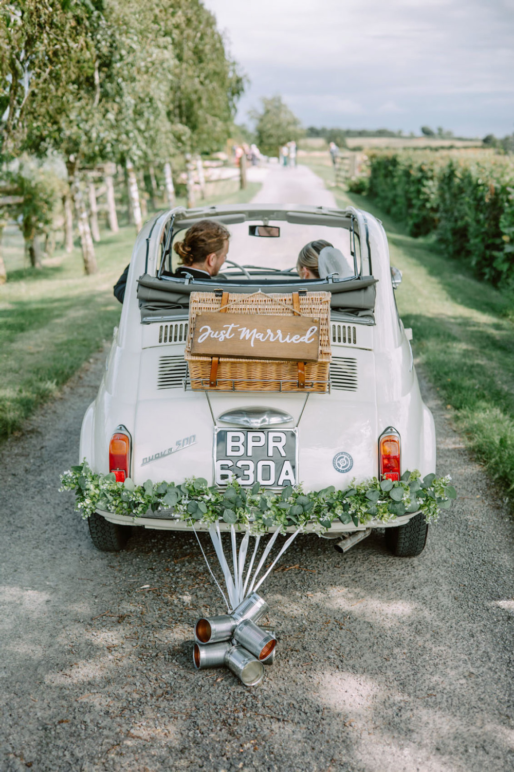 Newlyweds sitting in the Fiat 500 on the Stratton Court Barn Wedding photographer