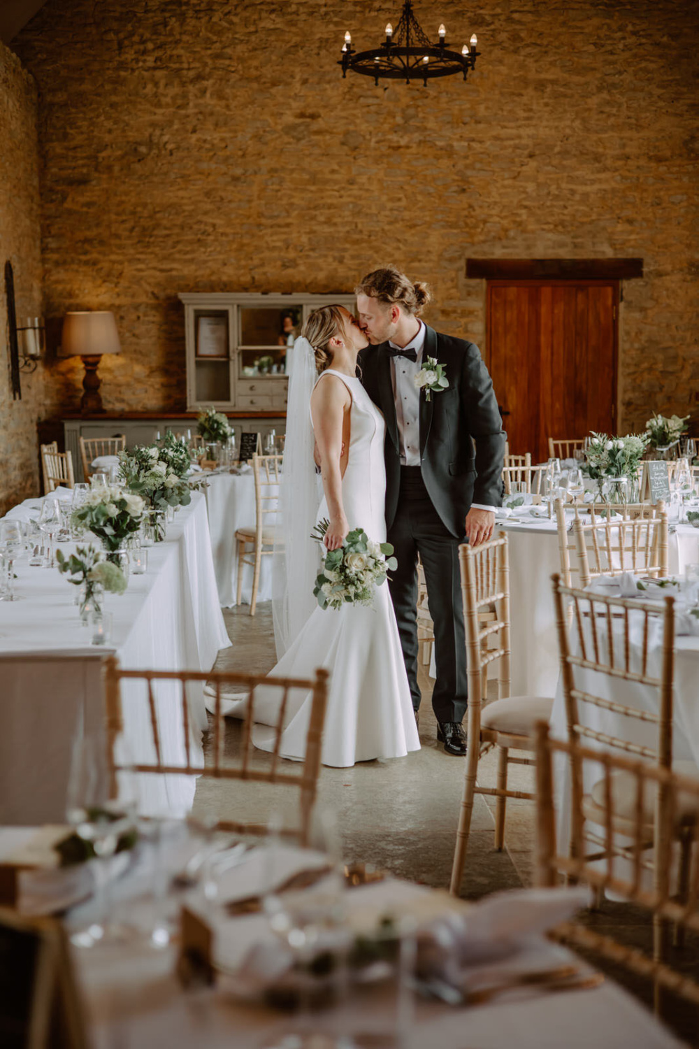 A bride and groom kissing at their wedding reception Stratton Court Barn.