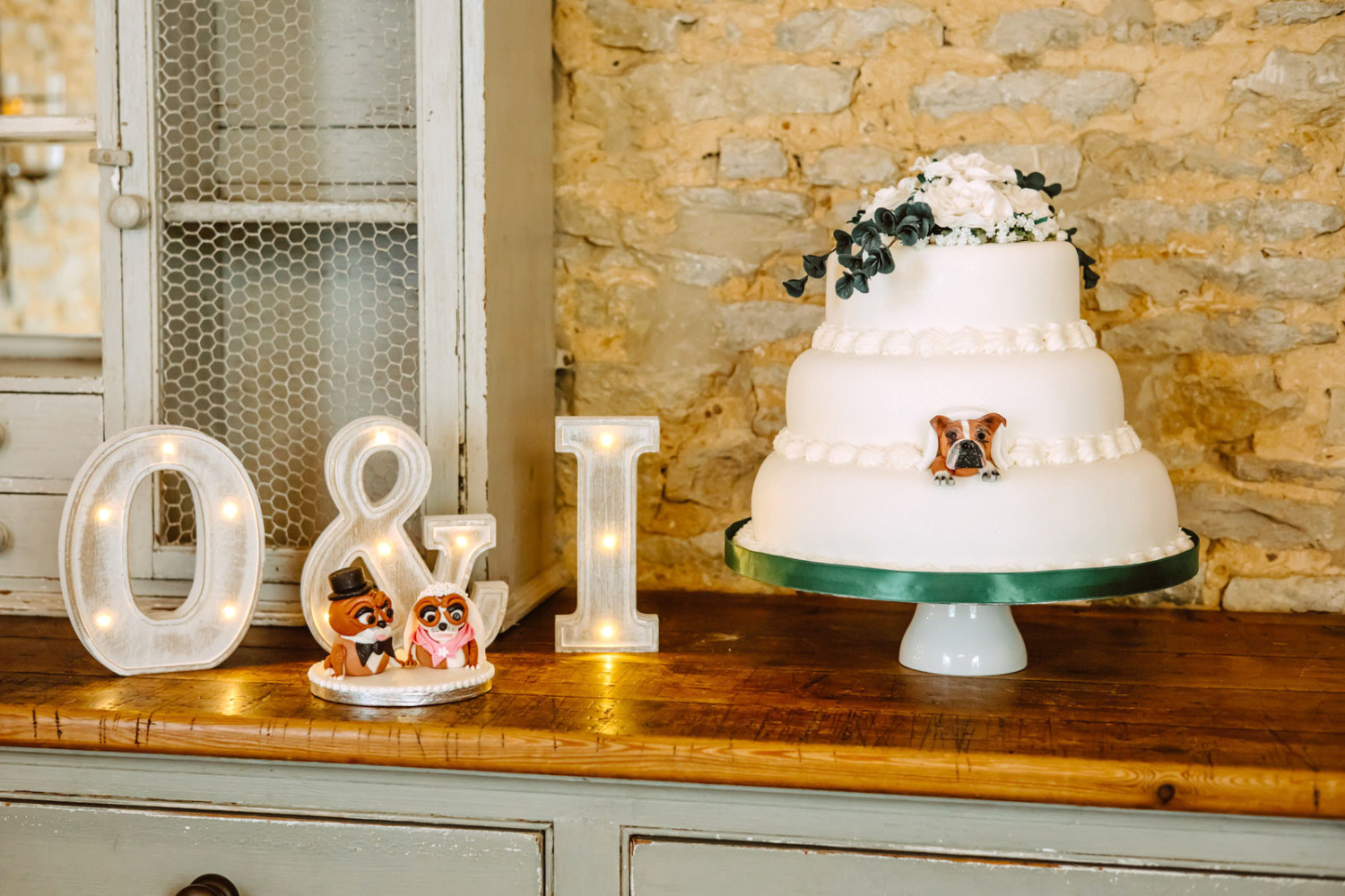 A wedding cake is sitting on top of a wooden table.