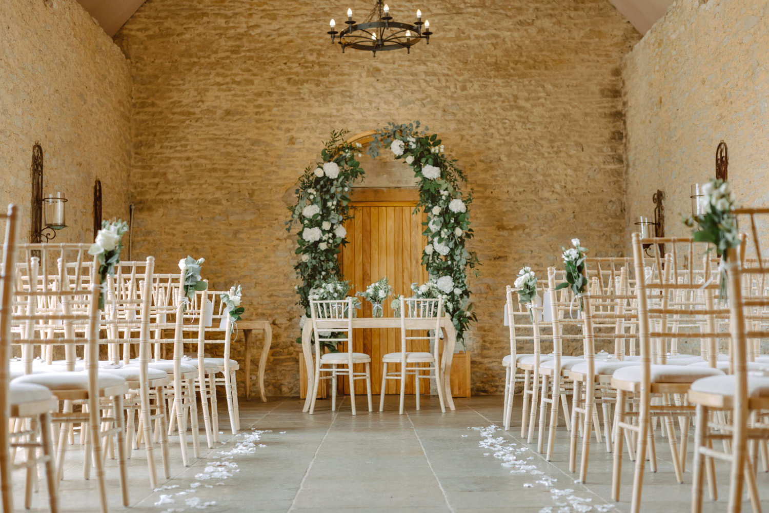 A wedding ceremony set up in a stone Stratton court barn.