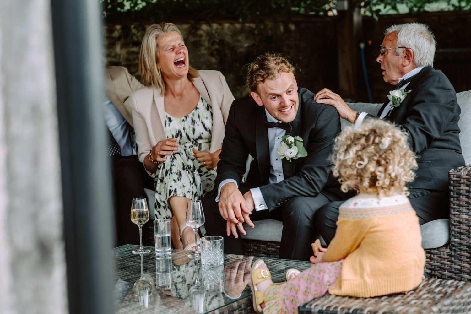 A group of people laughing at a wedding.