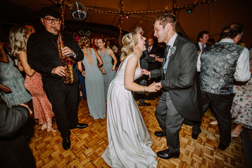 A bride and groom dancing at a wedding reception on the dance floor.