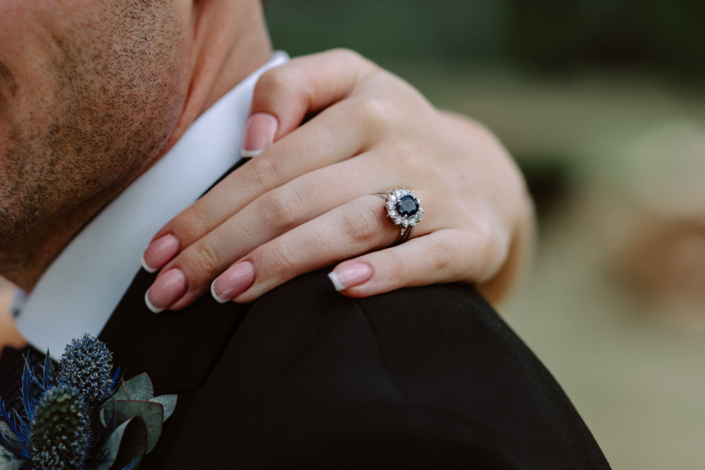 A man is holding a ring on his hand.