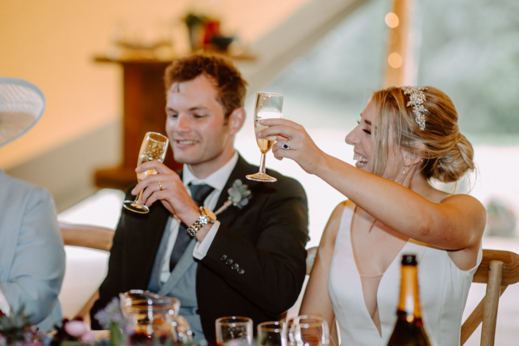 A bride and groom toasting champagne at their wedding reception.