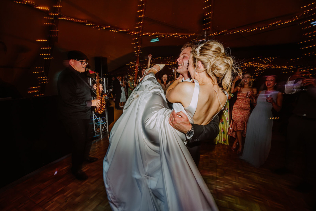 A bride and groom dancing at a wedding reception.