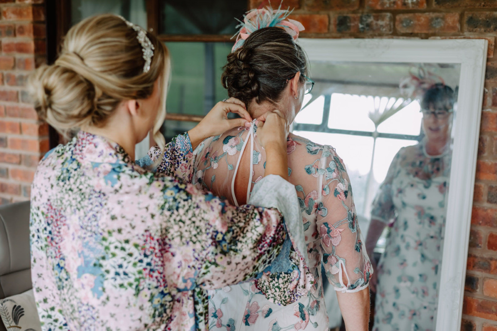 A bride helping her mum to dress up.