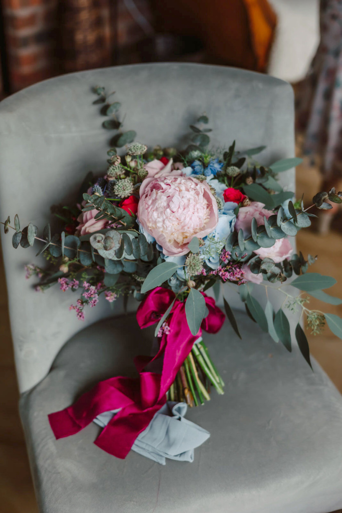 A wedding bouquet is sitting on a chair.