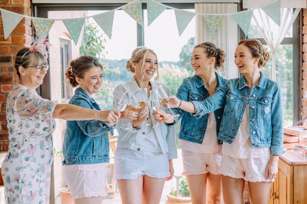 A group of women holding wine glasses smiling.