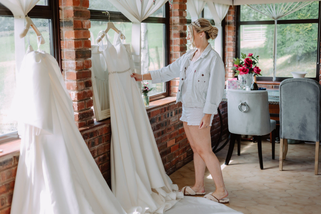 A bride looking at a wedding dress.