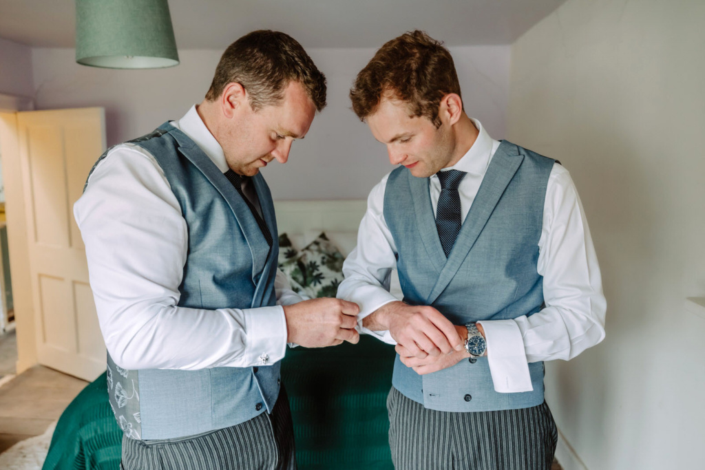 A groom looking at his wrist.