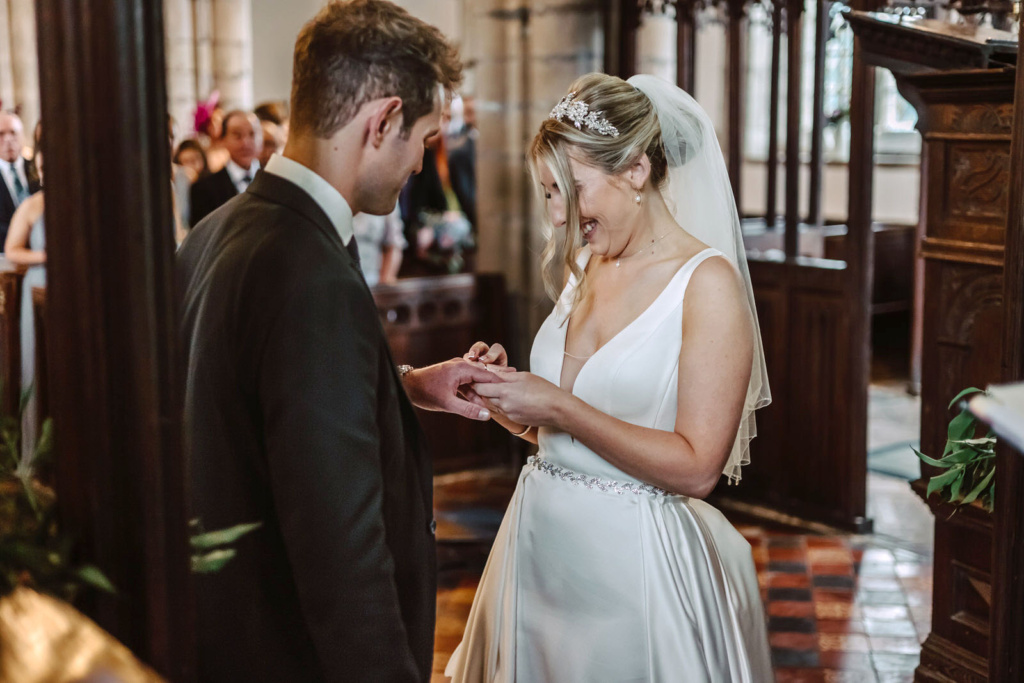 A bride and groom exchanging rings in a church.