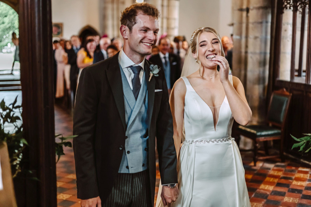 A bride and groom laughing at their wedding ceremony.