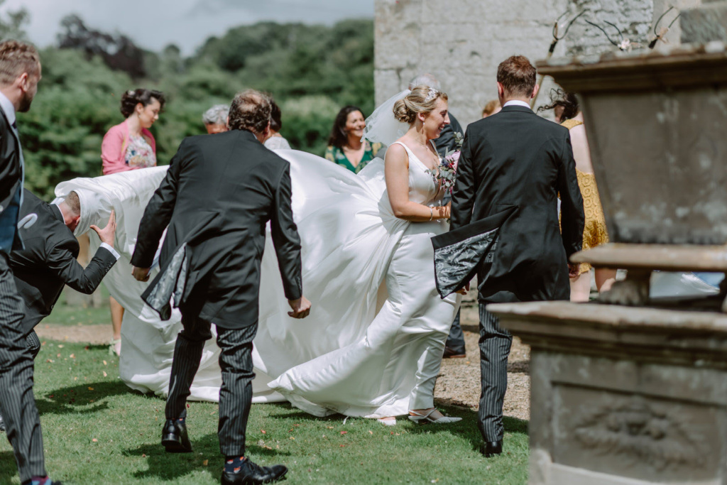 A bride and groom are walking down the aisle at a wedding.