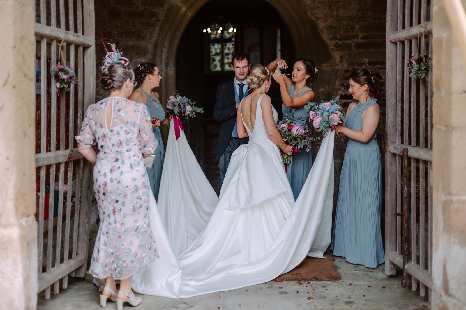 A bride and her bridesmaids are getting ready in a church.