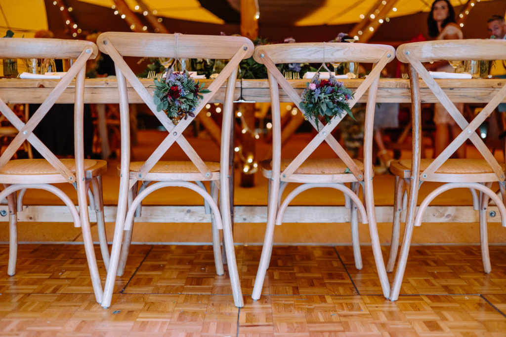 A wooden table with chairs in front of it.