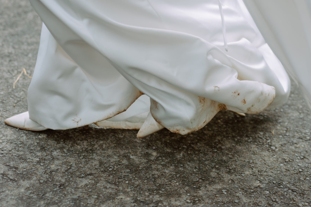 A woman in a white dress walking down the street.