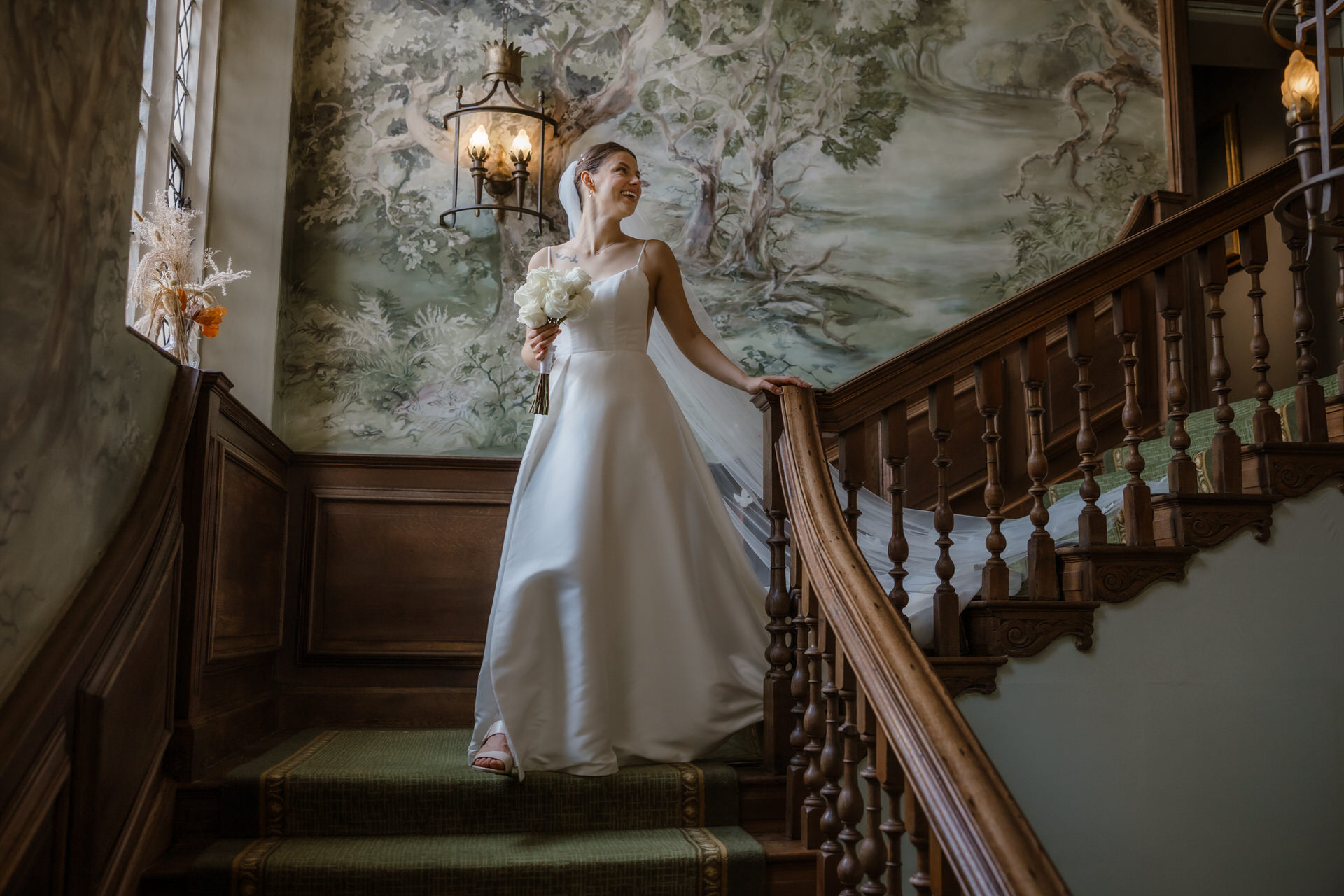 The Bride walking down the staircase at Ellenborough Park.