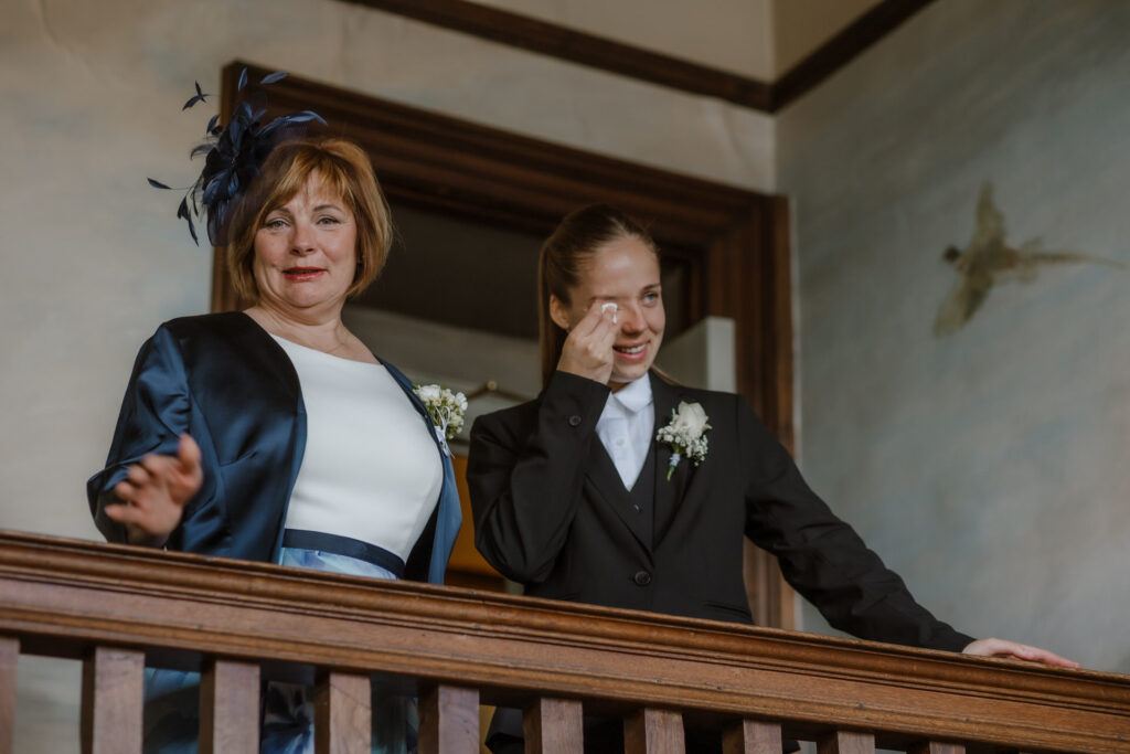 The mother of the bride and sister could not contain their tears as the bride descended the grand staircase
